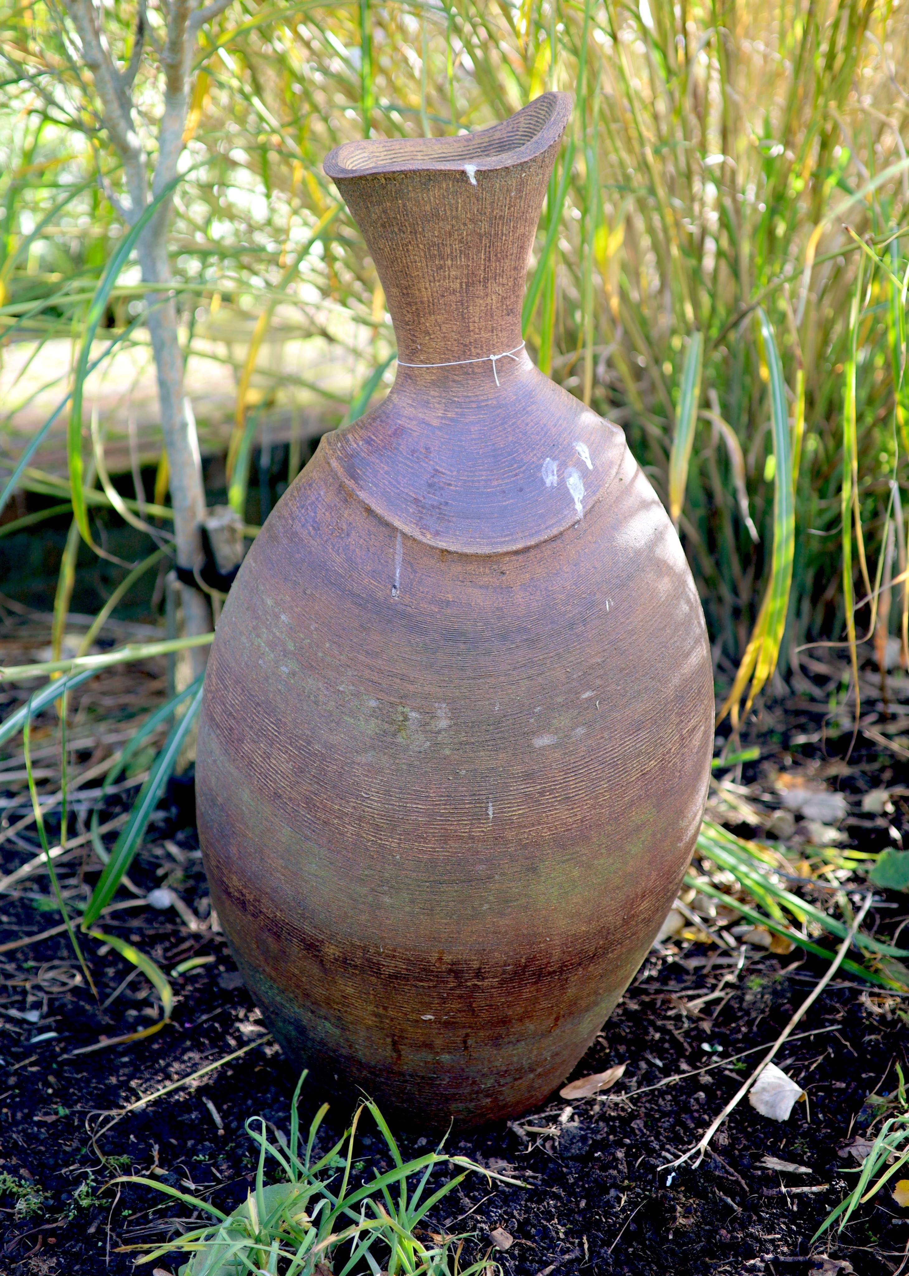 A terracotta garden urn ornament, height 86cm